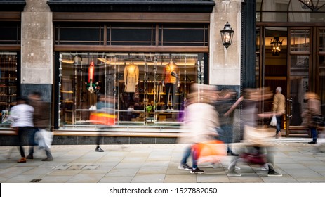 Motion blurred people on busy shopping street