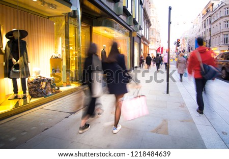 Motion blurred people walking on luxury shopping street