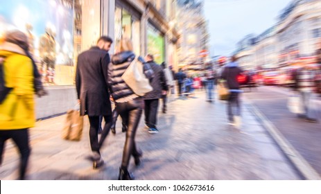 Motion Blurred Shoppers Walking On Busy High Street