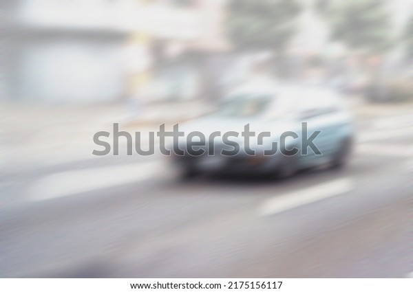 Motion blurred street life. Busy street in day\
time. Bokeh mode photo shot in day time of busy street with a car.\
Abstract blurred of vehicle on street. People driving car on day\
time background