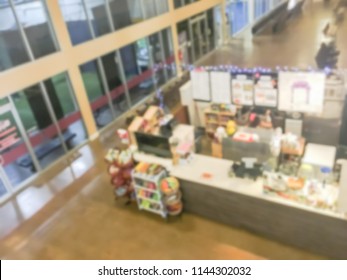 Motion Blurred Top Down View Compact Juice Bar And Café In US Shopping Mall. Blurry Food Kiosk Booth Counter With Bartenders Mixing The Beverage