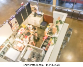 Motion Blurred Top Down View Compact Juice Bar And Café In US Shopping Mall. Blurry Food Kiosk Booth Counter With Bartenders Mixing The Beverage