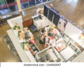 Motion Blurred Top Down View Compact Juice Bar And Café In US Shopping Mall. Blurry Food Kiosk Booth Counter With Bartenders Mixing The Beverage