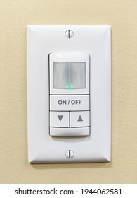 A Motion Detection Light Switch On A Yellow Wall