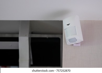 Motion detector attached on blue wall - Shutterstock ID 757252870