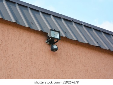 Motion Flood LED Light. Installing  Motion Detector Lighting. Close Up On Motion Sensor.