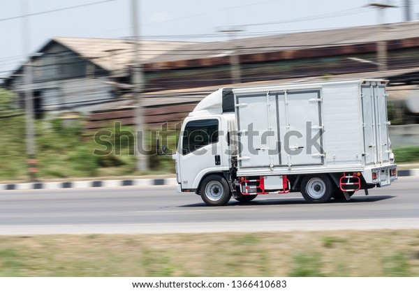 Motion image, Small white truck for logistics on\
the road.