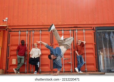 Motion Shot Of All Male Dance Team Performing Hip-hop And Breakdance In Urban City Setting, Focus On Man Doing Handstand Pose