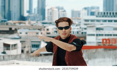 Motion shot of B-boy dance performance by professional street dancer at rooftop with sky scrapper, city view. Attractive asian hipster show energetic footstep. Outdoor sport 2024. Closeup. Hiphop. - Powered by Shutterstock