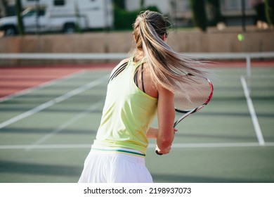 Motion Shot Of Blonde Athlete With Long Pony Tail Being Active D