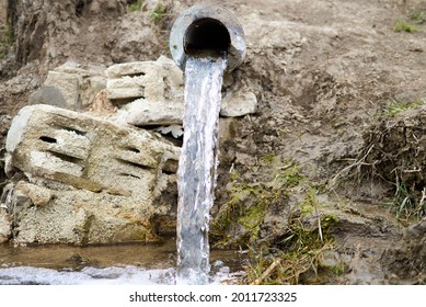 Motion Of Storm Water Runoff Flowing Through Drainage Culvert Under Road