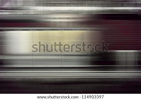 Motion stripes of a passing red train in a railroad station. German railroad/Passing train