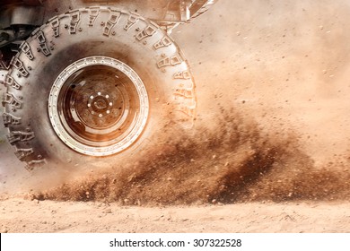 Motion the wheels tires and off-road that goes in the dust of the desert through the wheels on the sand - Shutterstock ID 307322528