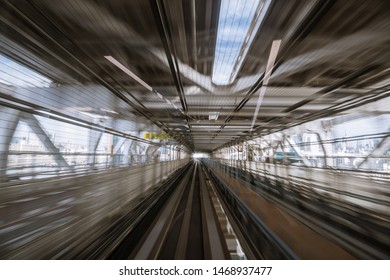 motion-blurred view from a moving train running in tunnel. The Japanese on the image means 