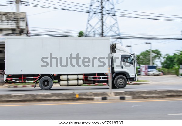 Motion,small white\
truck for logistics on the\
road.