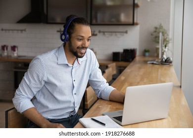 Motivated black man in headphones spend time for distant learning talk to teacher group mates on web conference. Confident biracial guy student get personal video consultation from tutor by video call - Powered by Shutterstock