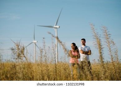 Motivated couple of young athletes standing with arms crossed at countryside during outdoor running training. Confident sporty man and woman taking a workout break. - Shutterstock ID 1102131998