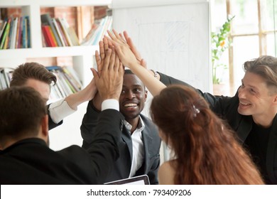 Motivated Excited Multiracial Business Team Giving High Five Celebrating Corporate Growth And Financial Success, Diverse Group Of Colleagues Join Hands Together Showing Unity Help Support In Teamwork