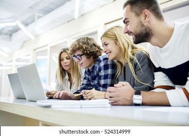 Motivated female and male students working together in group on university coursework about social media using laptop computers and fast 4G internet sitting in campus library in friendly atmosphere - Powered by Shutterstock