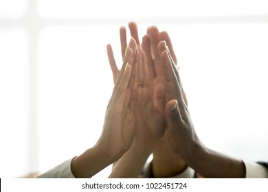 Motivated Multiracial Business Team Join Hands Palms Together, Black And White Diverse People Group Give High Five As Concept Of Successful Teamwork And Help Support Unity In Common Goal Achievement