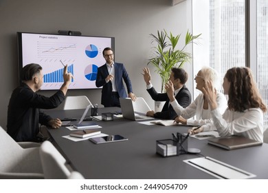 Motivated professional team members gathered together at corporate seminar raise hand, voting unanimously, agree with solution, express opinion and position. Election, engagement, business training - Powered by Shutterstock