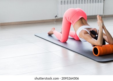 Motivated Sporty Woman Training On Mat Indoor Winter Day, Using Foam Roller Massager For Relaxation, Stretching Spine Muscles, Doing Fascia Exercise. Health Care, Workouts Routine