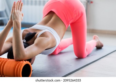 Motivated Sporty Woman Training On Mat Indoor Winter Day, Using Foam Roller Massager For Relaxation, Stretching Spine Muscles, Doing Fascia Exercise. Health Care, Workouts Routine