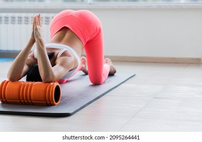 Motivated Sporty Woman Training On Mat Indoor Winter Day, Using Foam Roller Massager For Relaxation, Stretching Spine Muscles, Doing Fascia Exercise. Health Care, Workouts Routine