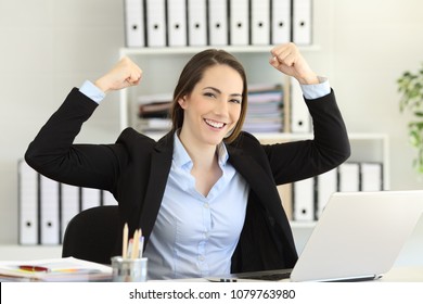 Motivated strong and confident businesswoman looking at camera at office