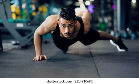 Motivated Young Arab Sportsman Making Push Up Exercise On One Hand, Portrait Of Handsome Muscular Middle Eastern Male Athlete Training In Modern Gym Interior, Doing Bodybuilding Workout, Panorama