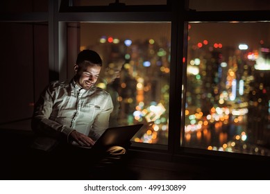 Motivated Young Man Working Late At Night.