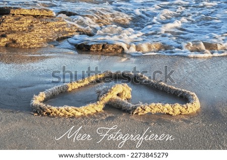 Motivating and inspirational ambiguous quote, life offer on the picture with a heart-shaped light dew on the beach, rocks and light waves with whitecaps in the background - sea photography
