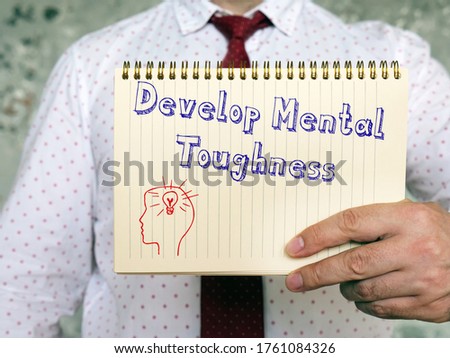 Motivation concept about Develop Mental Toughness with sign on the page.