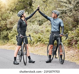 Motivation, cyclist and high five on bike break outdoors in the street. Success, goal and countryside sports environment for training. Nature, cycling and biking people exercising on scenic route. - Powered by Shutterstock