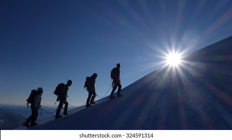 Motivation, Teamwork And Leadership - Mountaineering Rope Team At Sunrise