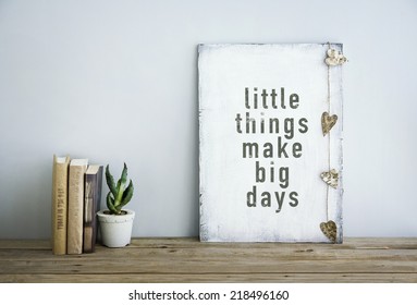 motivational inspirational poster quote LITTLE THINGS MAKE BIG DAYS with books and succulent - Powered by Shutterstock