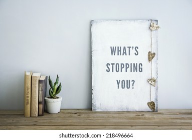 motivational inspirational poster quote WHAT'S STOPPING YOU. Room decoration american or scandinavian style  with books, succulent - Powered by Shutterstock