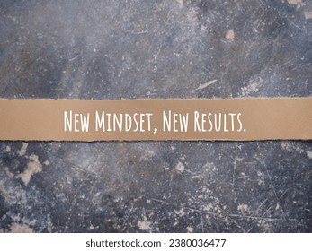 Motivational and inspirational wording. NEW MINDSET, NEW RESULTS written on a ripped paper. With blurred styled background.