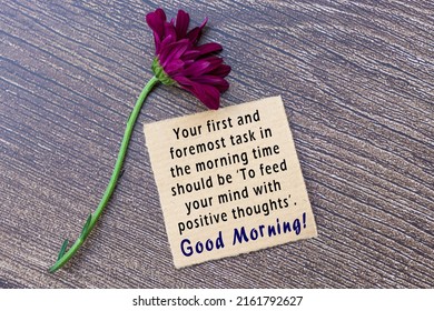 Motivational On Brown Note On Wooden Surface. Your First And Foremost Task In The Morning Time Should Be To Feed Your Mind With Positive Thoughts.