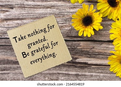 Motivational Quote On Torn Brown Paper - Take Nothing For Granted, Be Grateful For Everything.