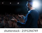 Motivational speaker with headset performing on stage