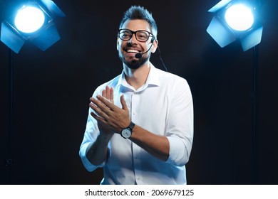 Motivational Speaker With Headset Performing On Stage