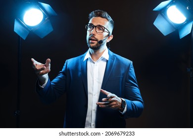 Motivational Speaker With Headset Performing On Stage