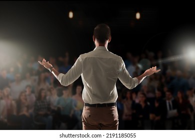 Motivational speaker with headset performing on stage, back view - Shutterstock ID 2191185055