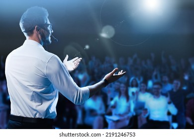 Motivational speaker with headset performing on stage