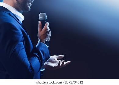 Motivational speaker with microphone performing on stage, closeup. Space for text - Shutterstock ID 2071734512