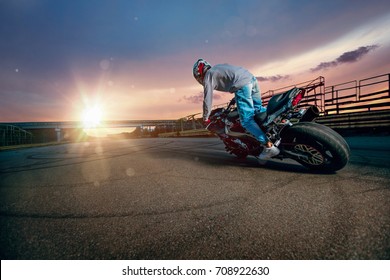 Moto Rider Making A Stunt On His Motorbike. Biker Doing A Difficult And Dangerous Stunt.