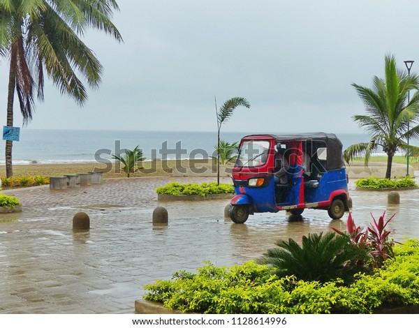 Moto Taxi\
Tuk Tuk on the street of Puerto Lopez, Ecuador, South America with\
Pacific view on background on rainy\
day.