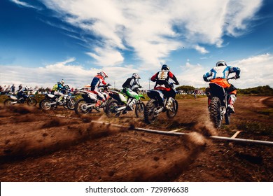 Moto. Team Athletes On Mountain Bike Motorcycles On Motocross Start