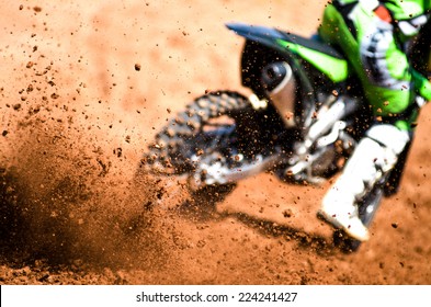 motocross racer accelerating in dirt track